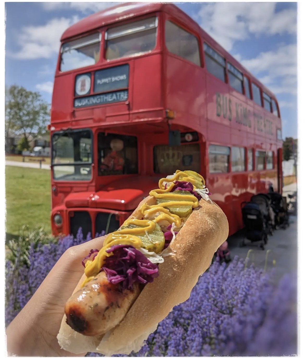 A Walthamstow Dogs hot dog in front of a red London bus