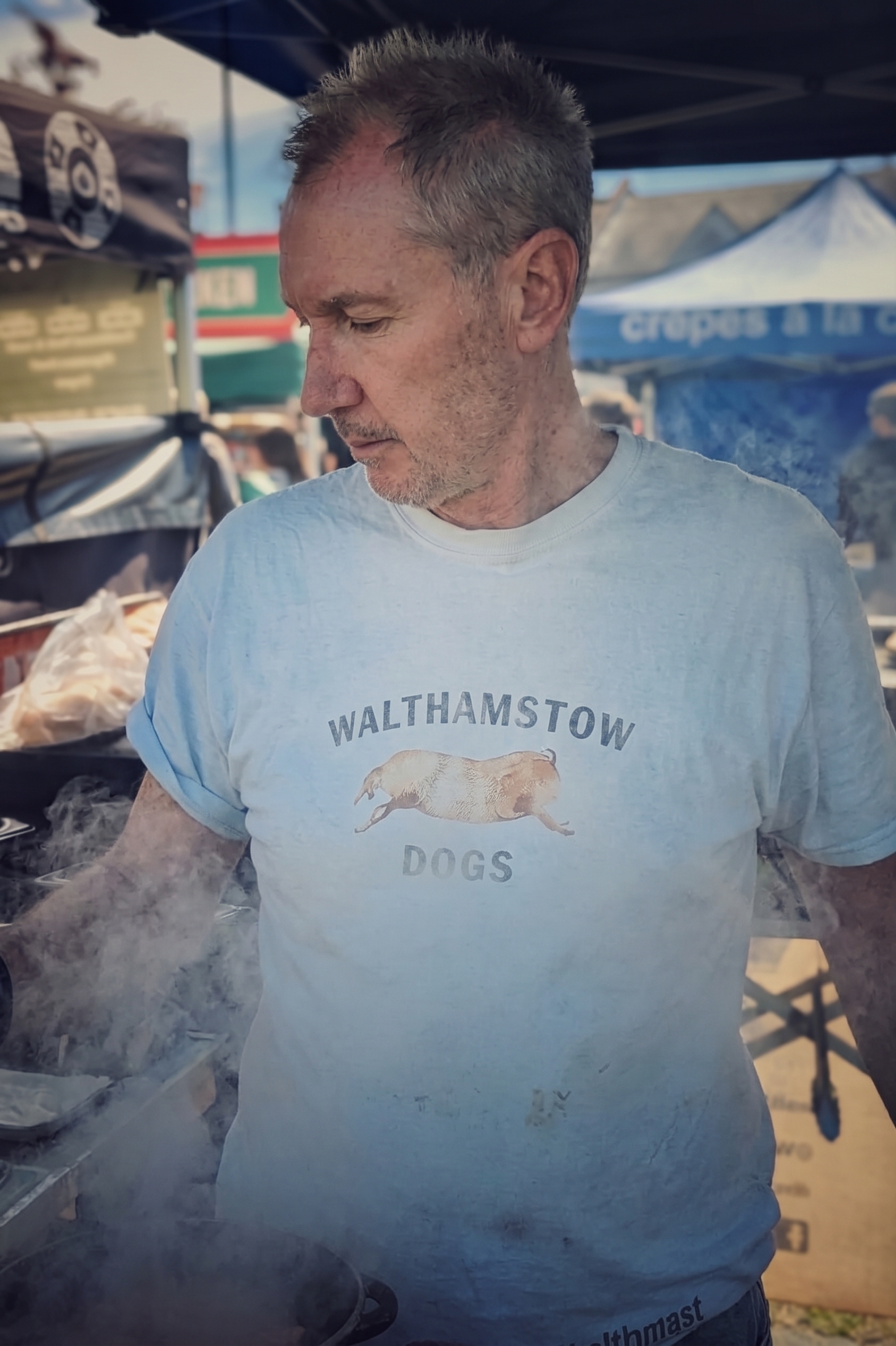 Walthamstow Dogs cooking sausages over a smoky grill